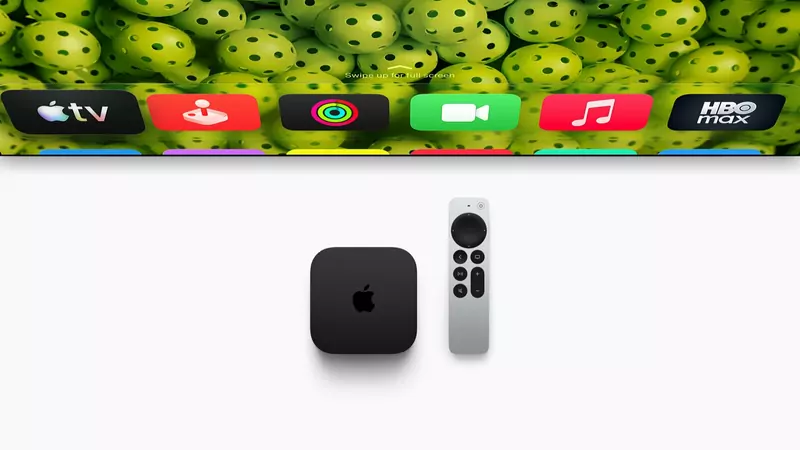 The black Apple TV 4K box next to its silver Siri Remote, below a TV home screen with app icons