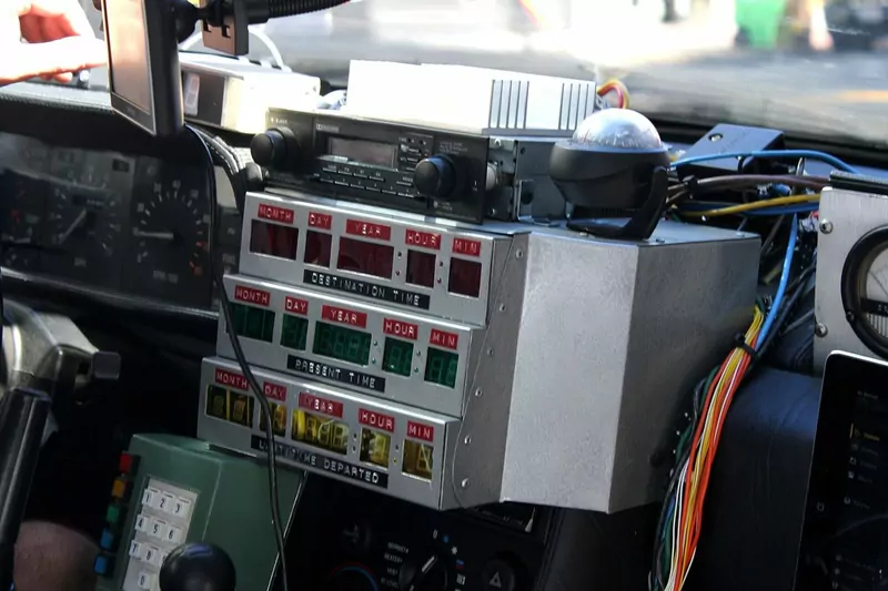 The stacked red, green and yellow digital date displays of a DeLorean replica's time circuits, labeled destination time, present time and last time departed