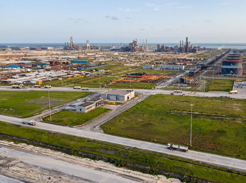 Aerial view of the Dangote refinery complex at Lekki, Lagos, with fuel tankers on the roads, storage tanks and process units on the horizon by the sea