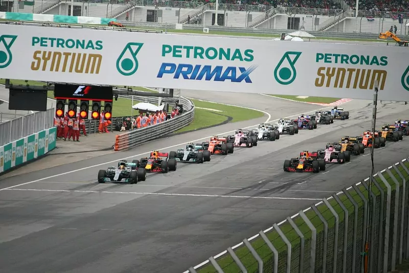 Formula 1 cars line up at the start of a Malaysian Grand Prix at Sepang as the red starting lights come on