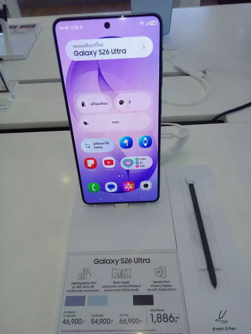 A Galaxy S26 Ultra in lavender on a shop display stand, with a printed price card below it