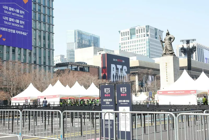 BTS banners, barriers and white tents set up in a city square in Seoul for the group's Arirang comeback show