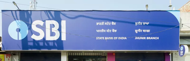 The blue State Bank of India sign above a branch in Punjab, with its name in English, Hindi and Punjabi
