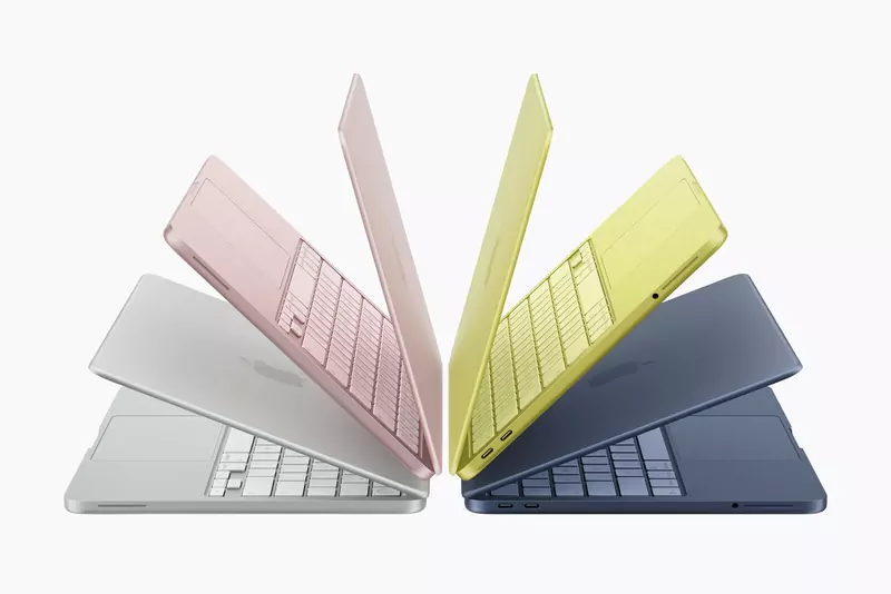 Four MacBook Neo laptops fanned out in silver, blush, citrus and indigo