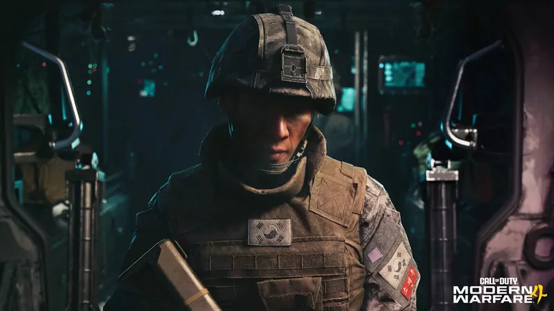 A South Korean soldier in a camouflage helmet and body armour inside a dim armoured vehicle, from Call of Duty: Modern Warfare 4