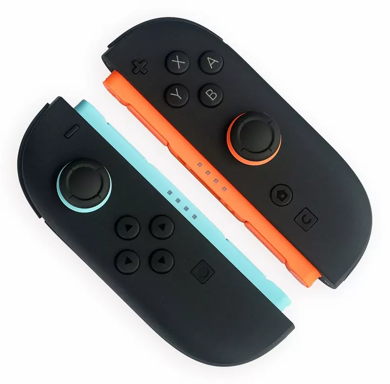 A pair of black Joy-Con 2 controllers, one with a light-blue inner edge and one with an orange one