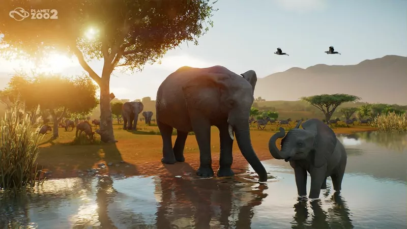 Two elephants, an adult and a calf, standing in a watering hole at sunset in a Planet Zoo 2 Wildlife Reserve