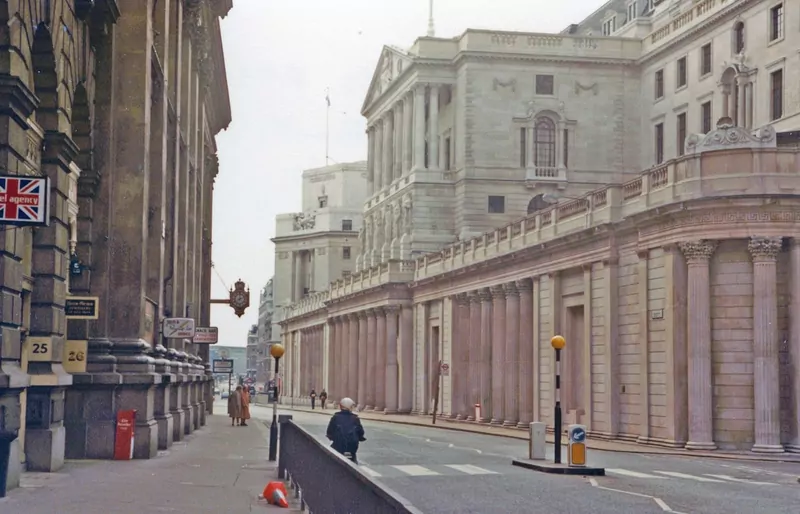 An almost empty City of London street with the curved stone wall of the Bank of England on the right