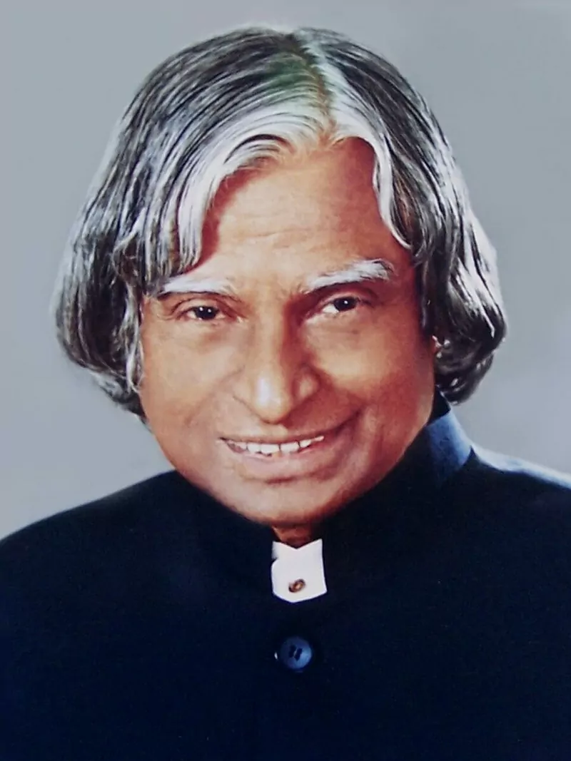 Official portrait of Dr. A. P. J. Abdul Kalam with silver hair, smiling, in a dark high-collared jacket